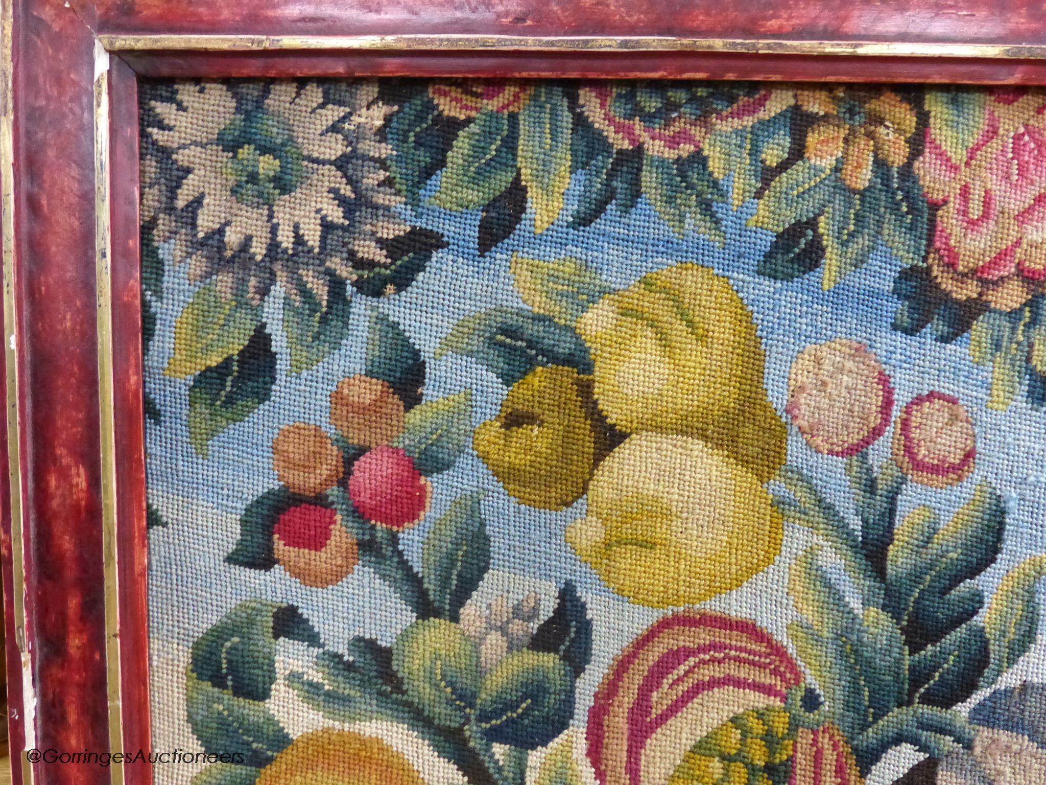 A framed 19th century woolwork panel depicting pomegranates, other fruit and flowers, 71 x 38cm
